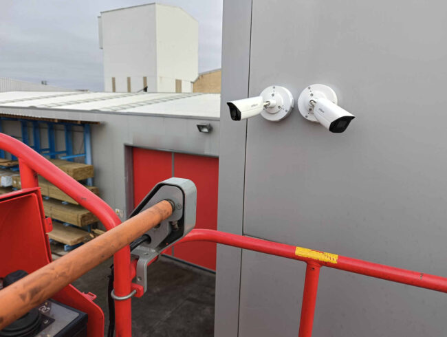 Cámaras de seguridad Dahua instaladas sobre cajas herméticas cerradas y orientadas para la vigilancia exterior de nave industrial