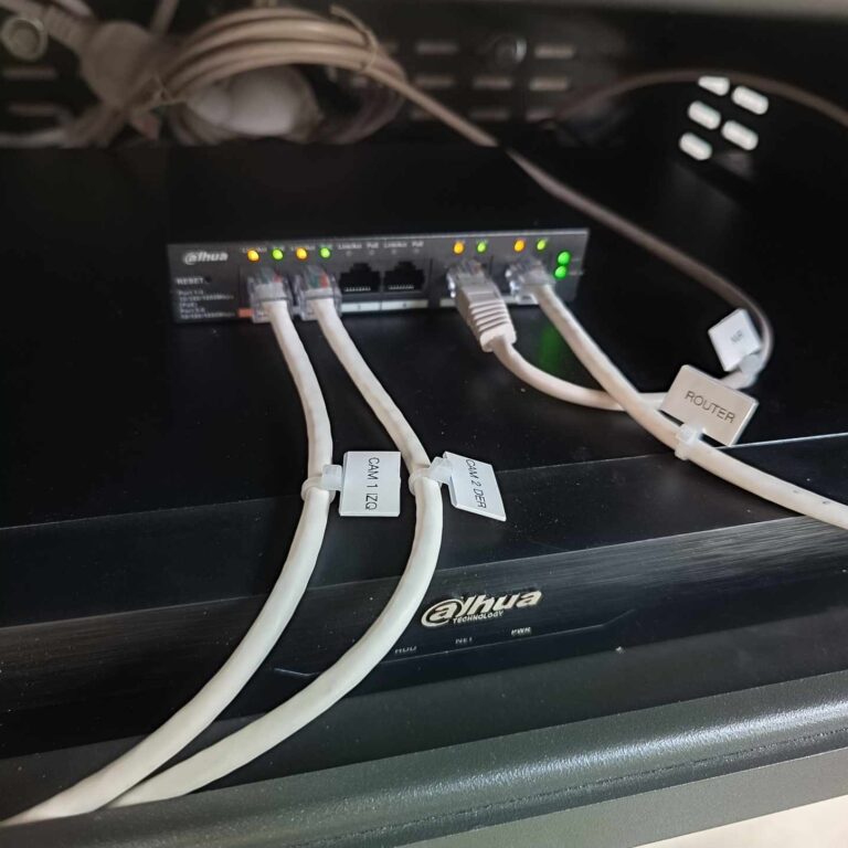 Detalle del cableado de red etiquetado de forma profesional en el interior del armario de seguridad, conectado al switch PoE del sistema de videovigilancia
